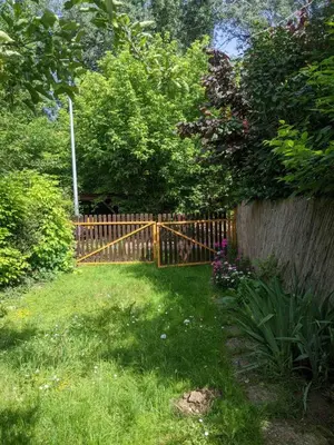 a wooden fence in front of a yard at Charming Vacation House in Belgrade