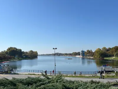a large body of water with people walking around it at Charming Vacation House in Belgrade