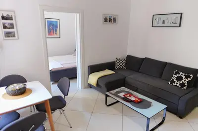 a living room with a couch and a table and a bed at Apartment Luna Terazije in Belgrade