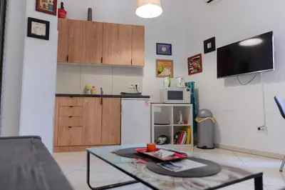 a living room with a table and a kitchen at Apartment Luna Terazije in Belgrade