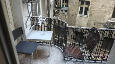 a table and chairs on the balcony of a building at Apartment Luna Terazije in Belgrade