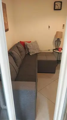 a brown couch in a living room with a table at Apartment Luna Terazije in Belgrade