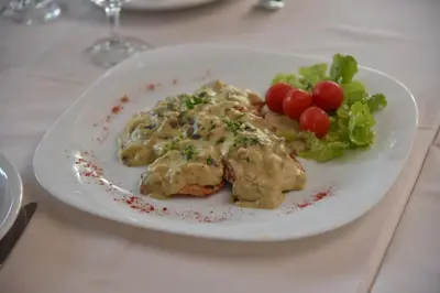 a white plate of food with vegetables on a table at B&B Park in Sremčica