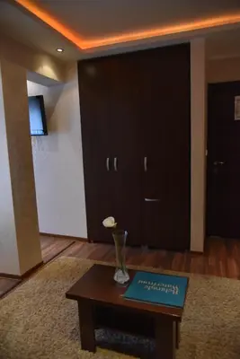 a living room with a table with a book on it at B&B Park in Sremčica