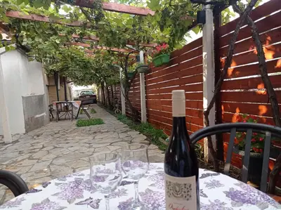 a bottle of wine sitting on a table with glasses at Meda Apartment in Belgrade