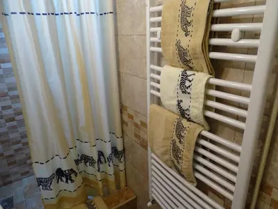 a shower curtain in a bathroom with towels at Meda Apartment in Belgrade