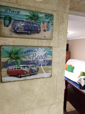 a wall with two posters of a beach party at Meda Apartment in Belgrade