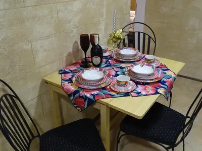 a table with plates and cups on it with two chairs at Meda Apartment in Belgrade