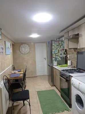 a small kitchen with a table and a stove at Meda Apartment in Belgrade