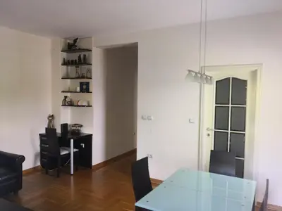 a dining room with a glass table and chairs at Ana's Apartment in Belgrade