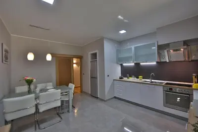 a kitchen with a counter and a table in it at Aber Apartment in Belgrade