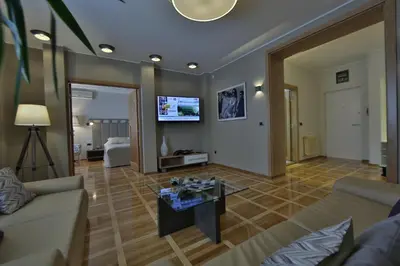 a living room with a couch and a table at Aber Apartment in Belgrade