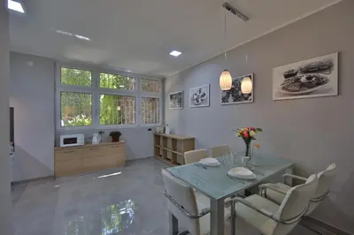 a dining room with a table and chairs at Aber Apartment in Belgrade