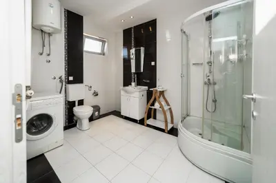 a bathroom with a shower toilet and a sink at Ring Inn Apartments in Obrenovac