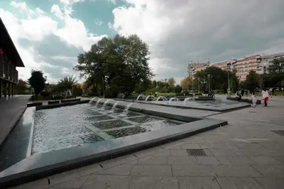 a fountain in a city with people walking around it at Apartment Charlie PERFECT PRICE in Belgrade
