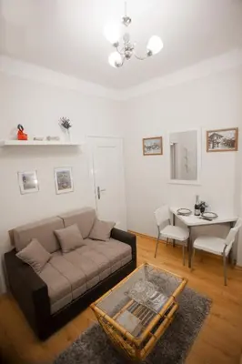 a living room with a couch and a table at Apartment Charlie PERFECT PRICE in Belgrade