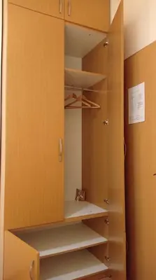 a closet with yellow walls and wooden cabinets at Belgrade Apartment Happy Garden in Belgrade