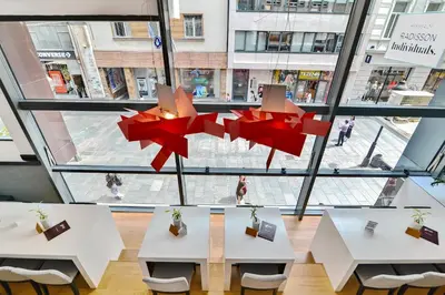 a room with two tables and a large window at Belgrade Art Hotel, a member of Radisson Individuals in Belgrade