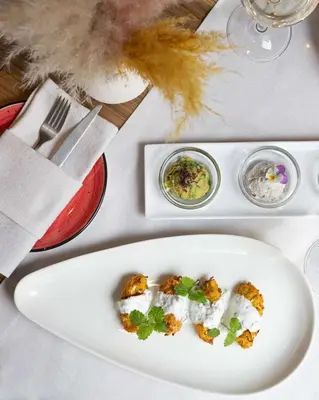 a white plate with food on a table at Belgrade Art Hotel, a member of Radisson Individuals in Belgrade