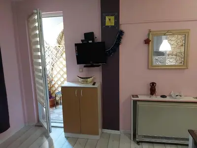 a room with a tv on the wall and a mirror at Keti 1 in Belgrade