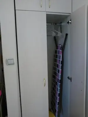 a closet with a white door and a purple tie at Keti 1 in Belgrade