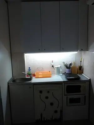 a kitchen with white cabinets and a sink at Keti 1 in Belgrade