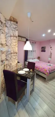 a bedroom with a dining table and a bed at Keti 1 in Belgrade