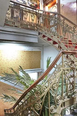 a spiral staircase in a building with a plant at Vila Terazije in Belgrade