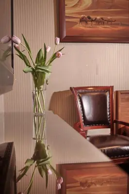 a vase filled with pink flowers on a table at Vila Terazije in Belgrade