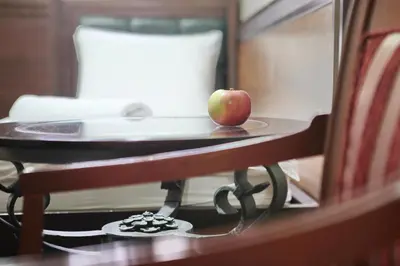 an apple sitting on a table in front of a mirror at Vila Terazije in Belgrade