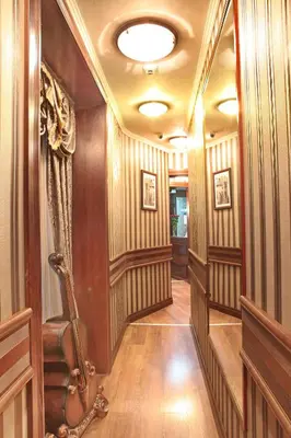 a hallway with wood paneled walls and a ceiling at Vila Terazije in Belgrade