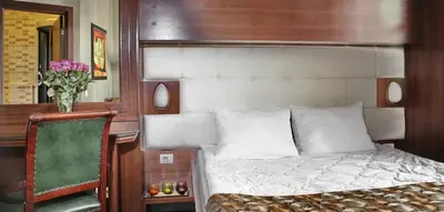 a bedroom with a bed and a desk and a chair at Vila Terazije in Belgrade