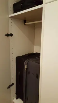 a suitcase is sitting on a shelf in a closet at Apartment Elza in Belgrade