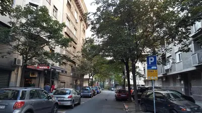 a street with cars parked on the side of the road at Apartment Elza in Belgrade