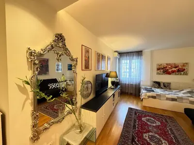 a living room with a mirror and a couch at Apartment Elza in Belgrade