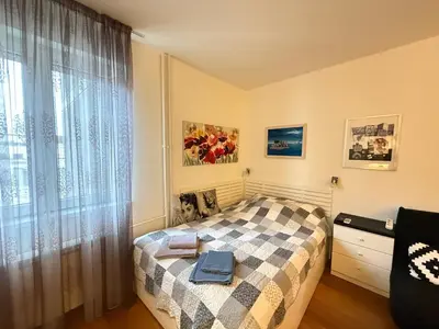 a small bedroom with a bed and a window at Apartment Elza in Belgrade