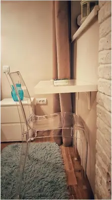 a room with a chair and a table and a rug at Apartment Cherry Queen in Belgrade