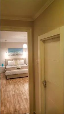 a bedroom with a bed and a painting of the ocean at Apartment Cherry Queen in Belgrade