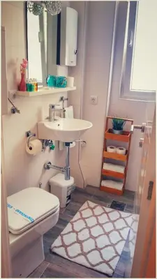 a bathroom with a sink and a toilet at Apartment Cherry Queen in Belgrade