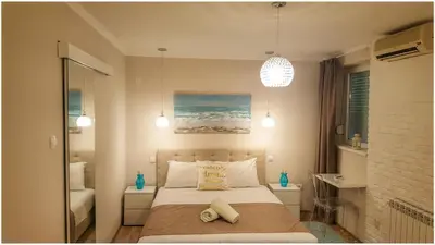 a bedroom with a bed with two pillows at Apartment Cherry Queen in Belgrade