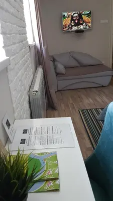 a living room with a table and a couch at Apartment Cherry Queen in Belgrade