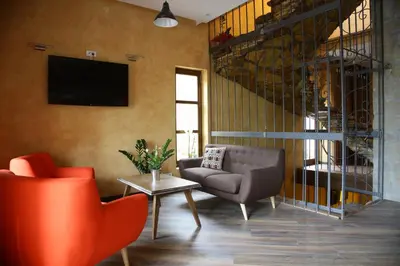 a living room with a couch and a chair at Garni Hotel Chicha - Winery ŠKRBIĆ in Belgrade