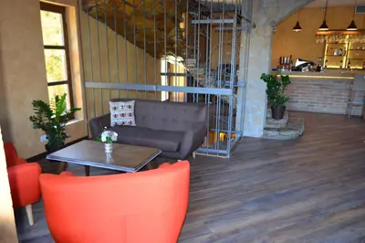 a living room with a couch and a table at Garni Hotel Chicha - Winery ŠKRBIĆ in Belgrade