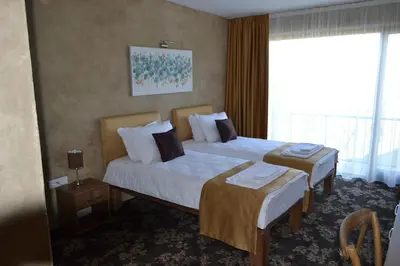 a hotel room with two beds and a window at Garni Hotel Chicha - Winery ŠKRBIĆ in Belgrade