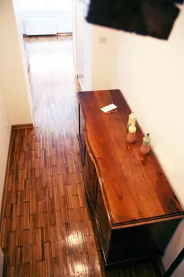 a wooden table in a room with a wooden floor at Apartment Auer_Belgrade in Belgrade