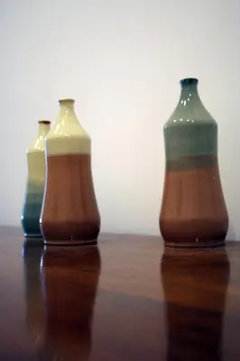 three vases sitting on top of a wooden table at Apartment Auer_Belgrade in Belgrade