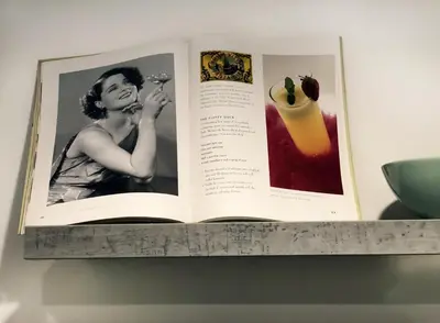 an open book on a shelf on a wall at Apartment Auer_Belgrade in Belgrade