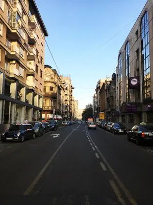 a city street with cars parked on the side of the road at Apartment Auer_Belgrade in Belgrade