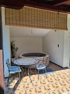 a patio with a table and two chairs and a fire pit at Apartment Aqua Royal in Arandjelovac