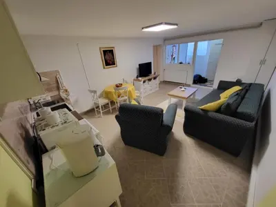 a living room with two couches and a table at Apartment Aqua Royal in Arandjelovac